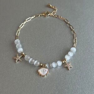 Gold and White Beaded Bracelet with Starfish Charms